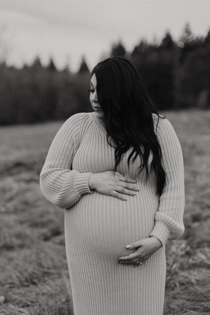 pregnant woman holds stomach during tacoma maternity shoot