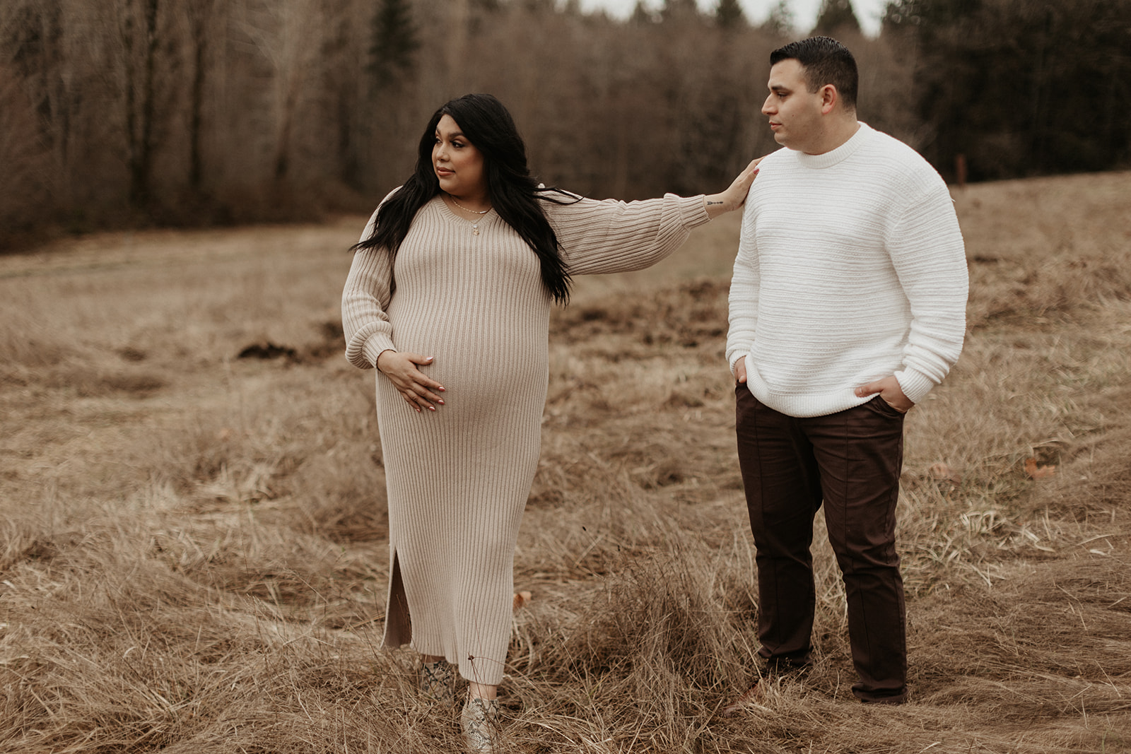 man and pregnant woman lay in brown field during gig harbor maternity  session