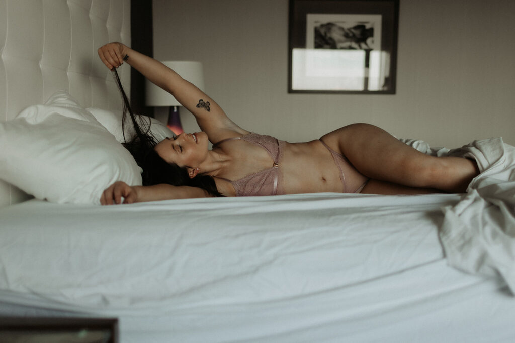 girl in pink lingerie relaxes on bed