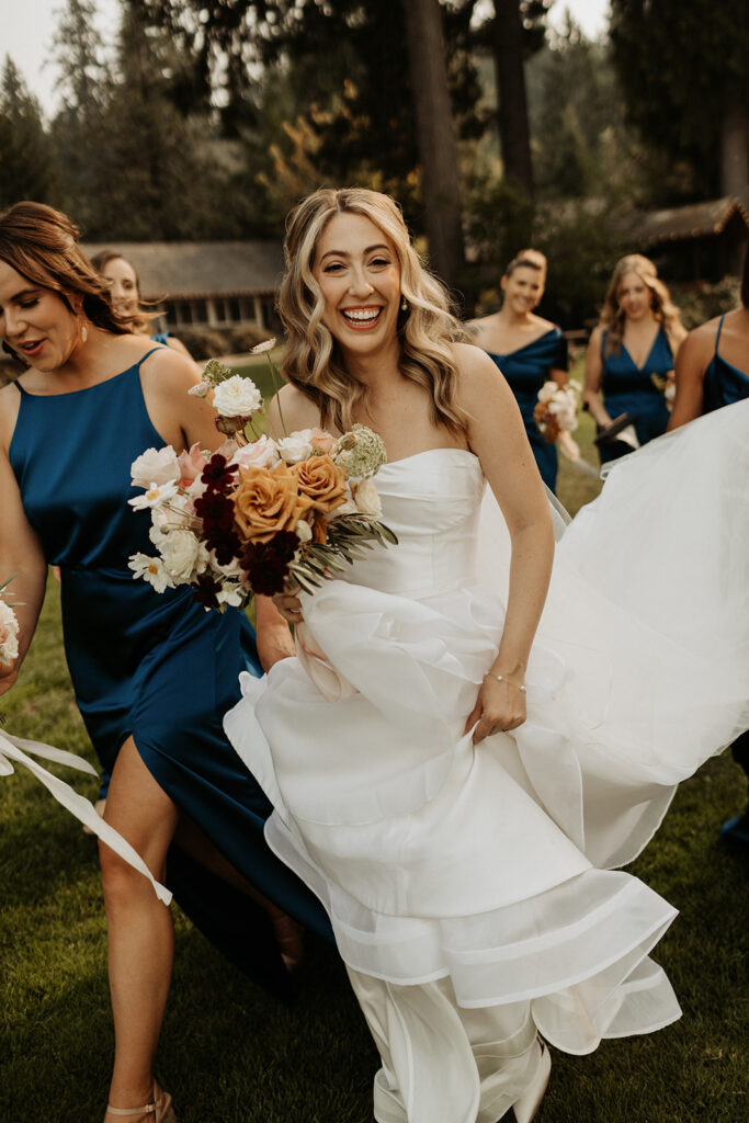 bride walks with bridesmaids in blue