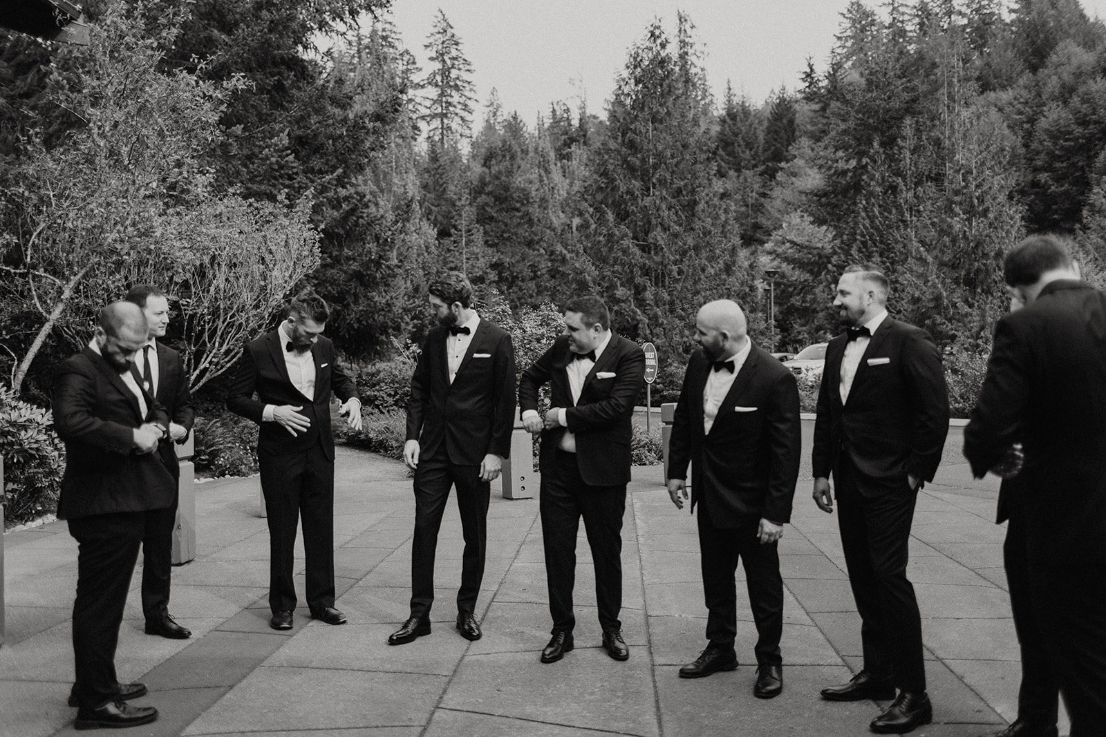groom stands with groomsmen before wedding at alderbrook resort