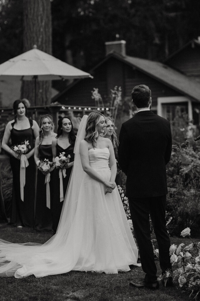 bride looks at groom during wedding ceremony at alderbrook resort