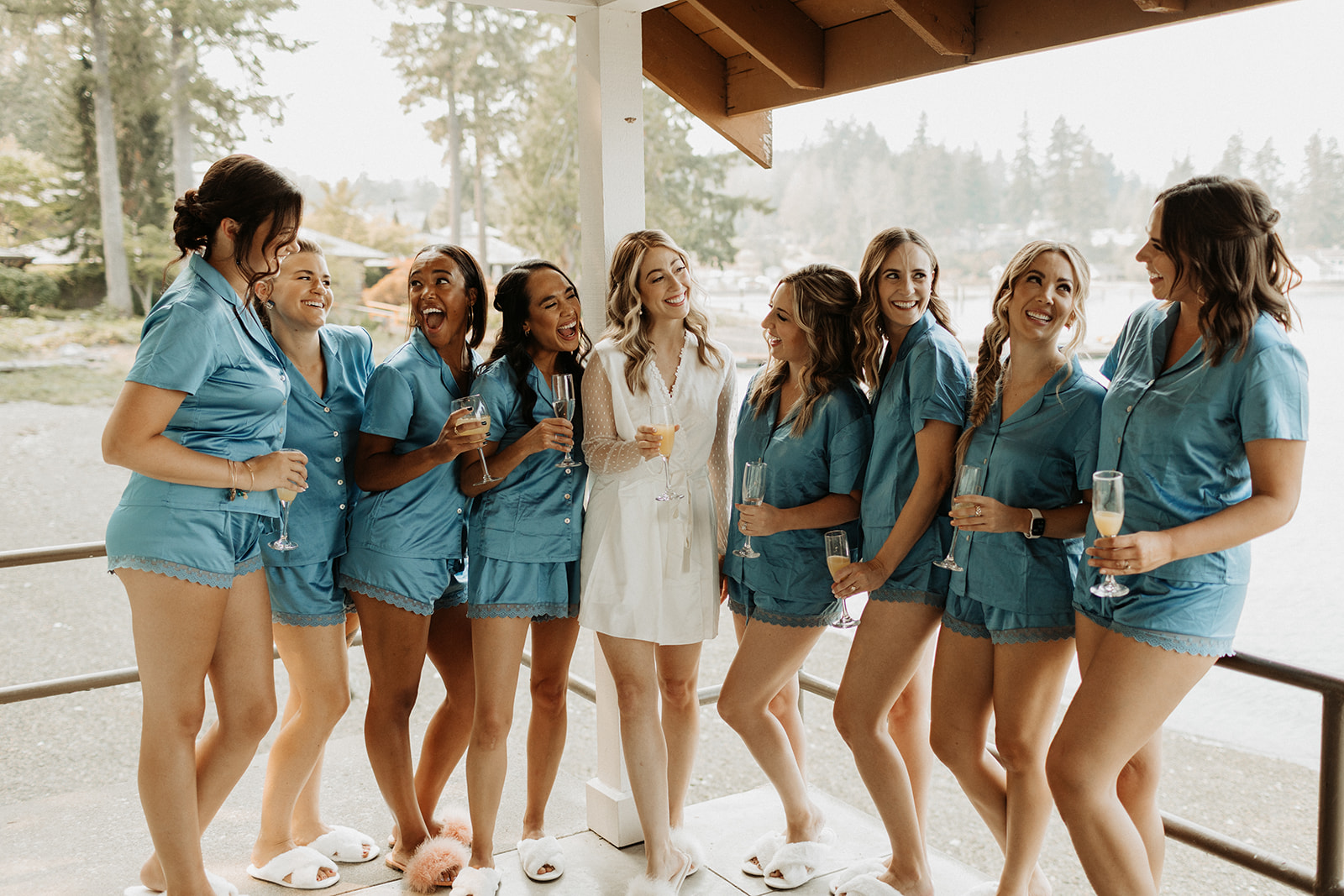 bride poses with bridemaids in blue robes