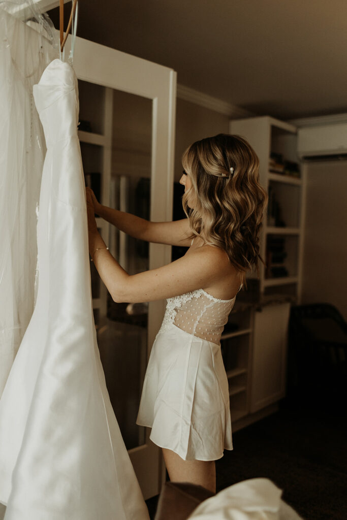 bride unzips wedding dress