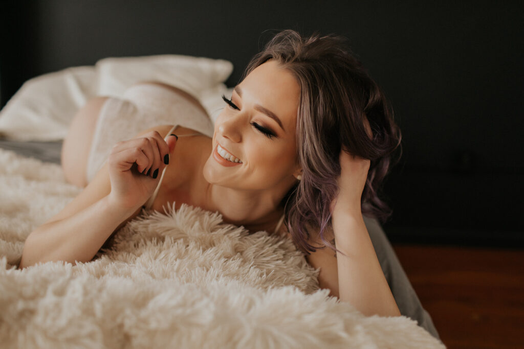 girl laughs during boudoir shoot