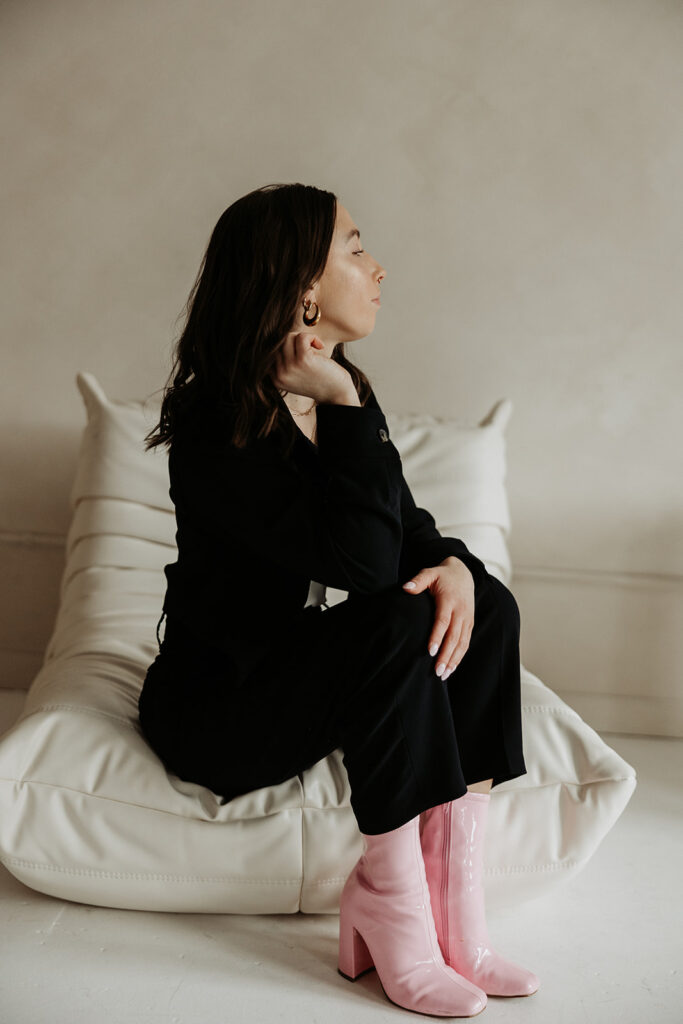 girl in blazer sitting on chair