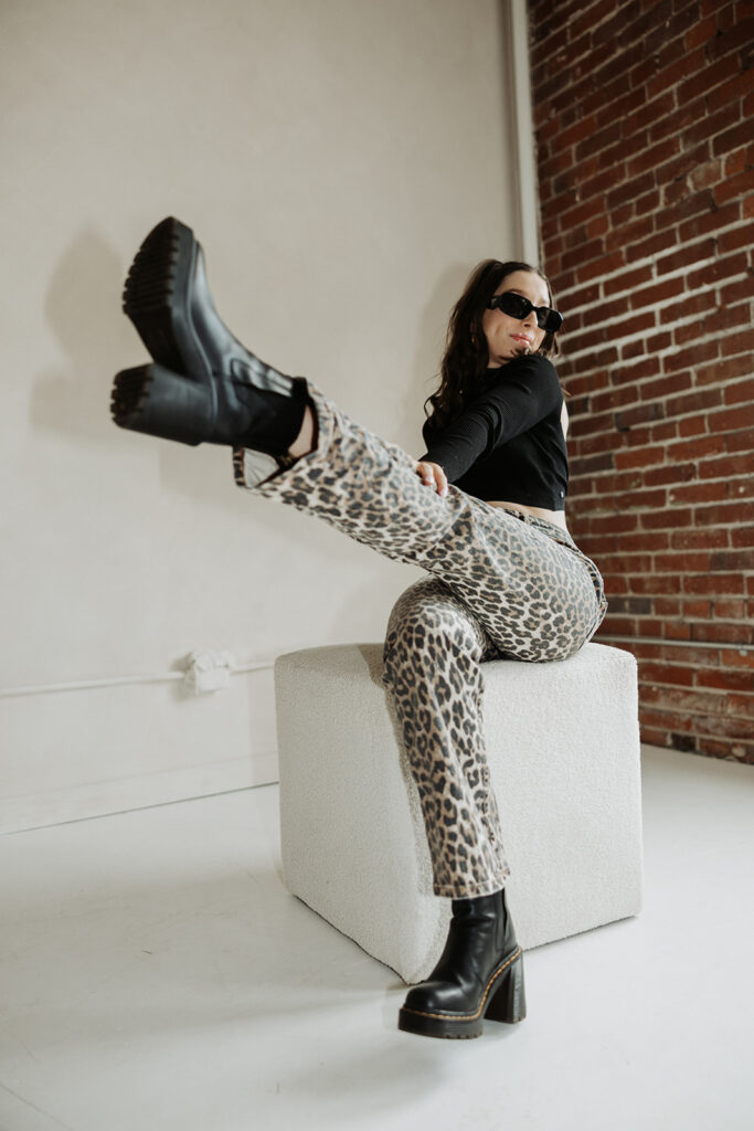 girl kicks the air wearing leopard pants